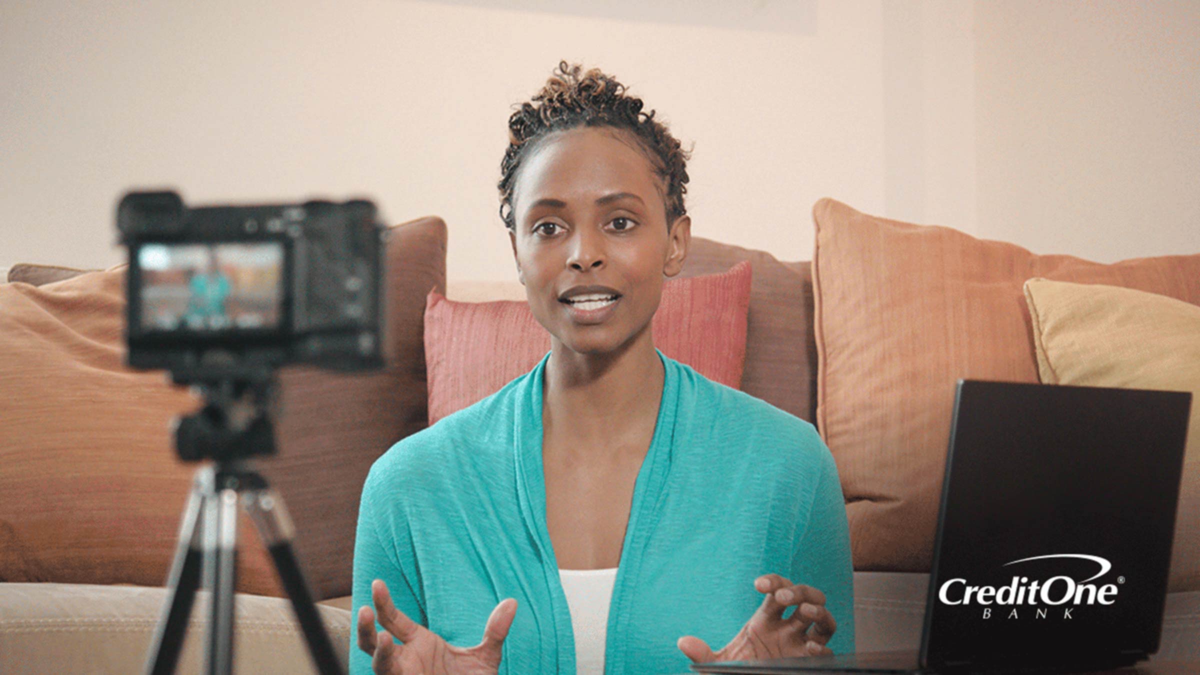 A women recording herself with a camera on a tripod