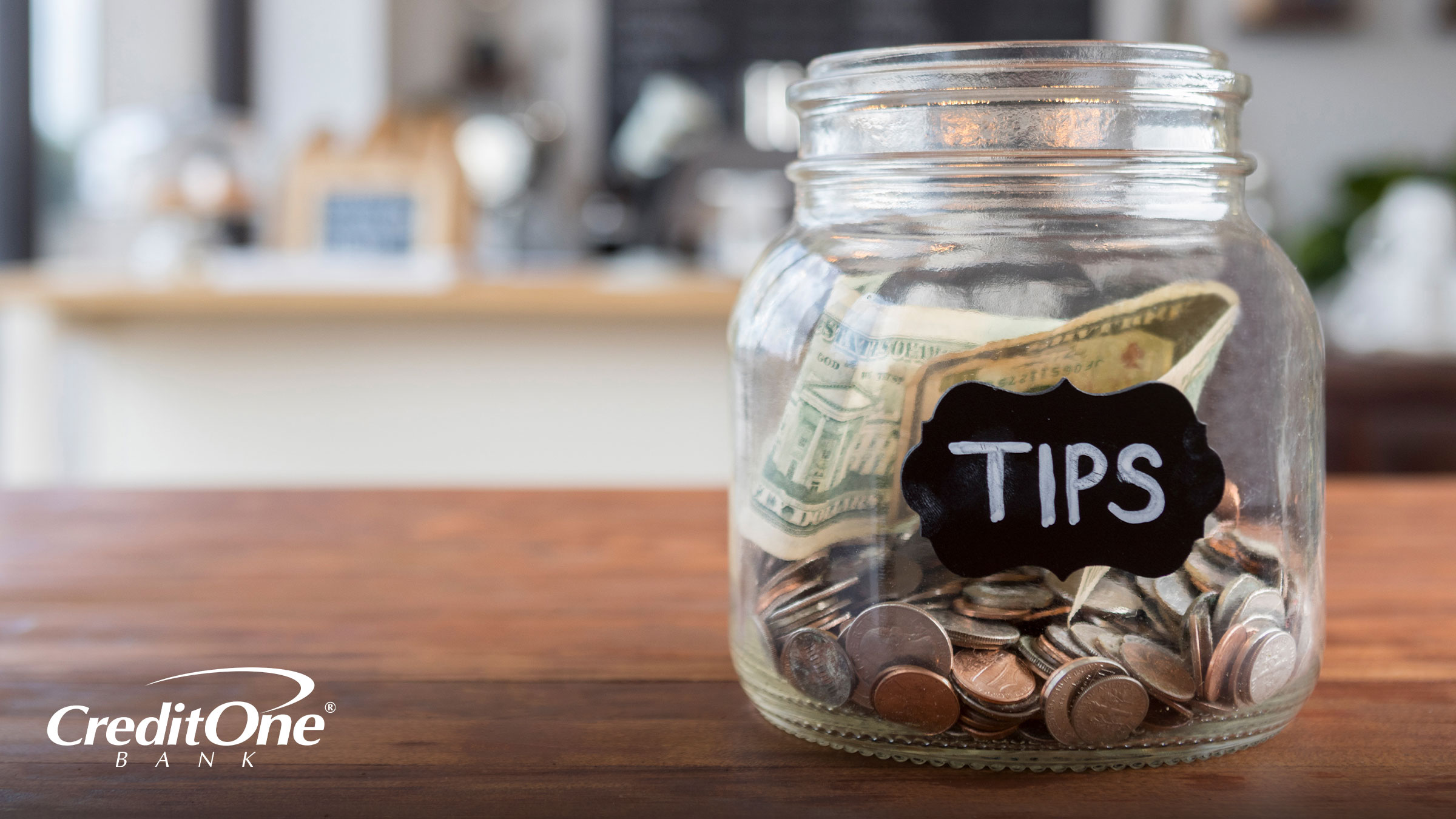 A tip jar sitting on a countertop.